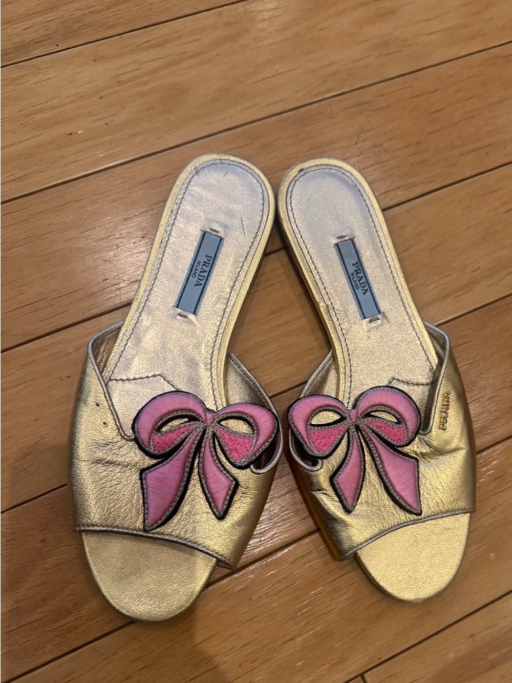 Prada Metallic Gold Slide Mules with Pink Bow Appliqués